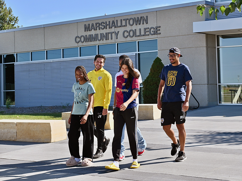 students walking out of Marshalltown Community College front entrance