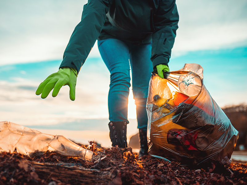 Student cleaning up trash. 