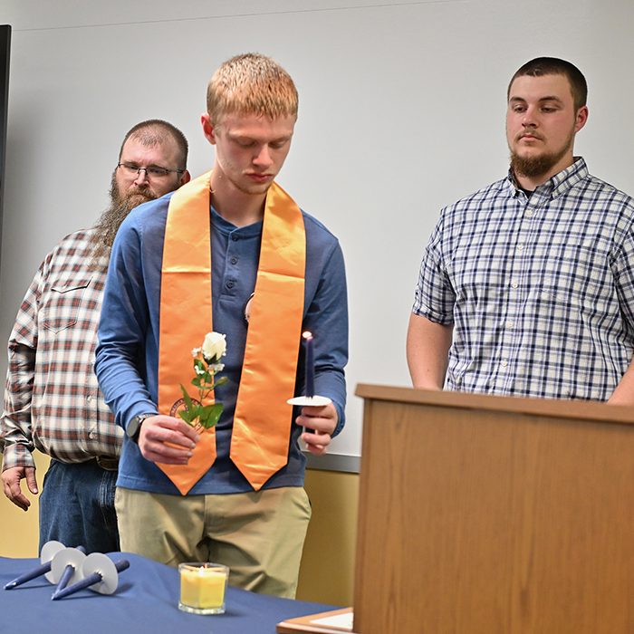 student-lighting-candle-at-PTK-ceremony