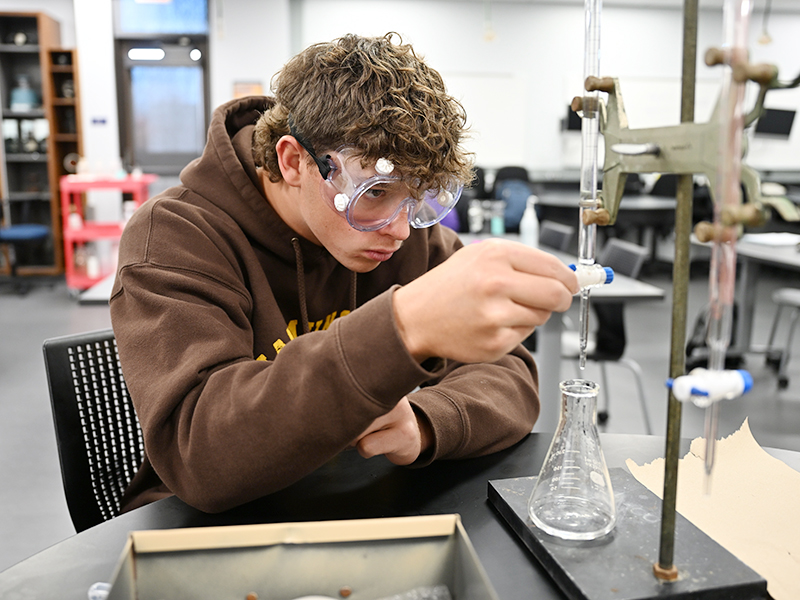 male student in science lab