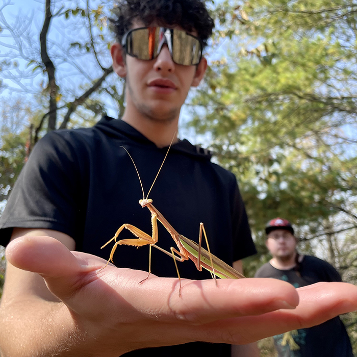 student holding bug