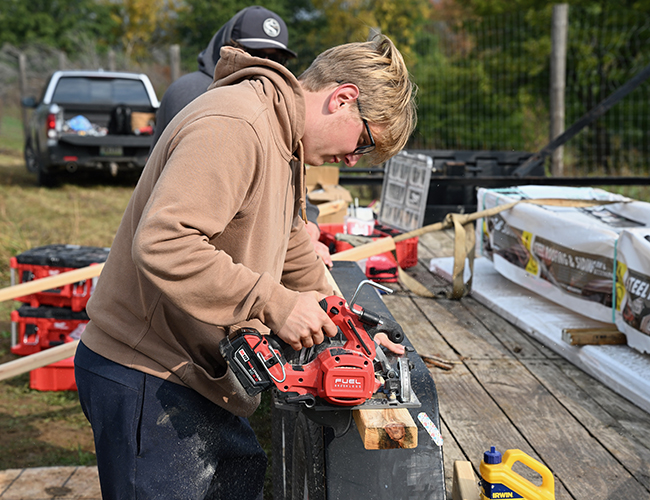 student using saw