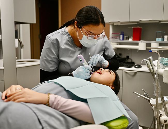 Dental Assisting dental student working on patient