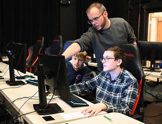 Esports Program Management Instructor working with student for seting up Esports event