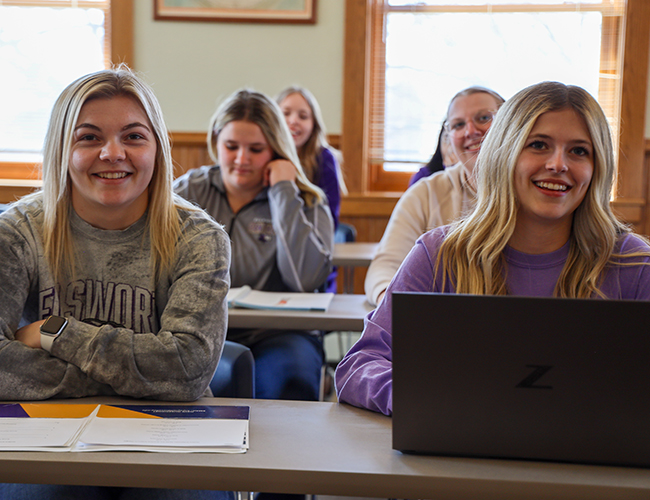 Students sitting in classroom listening to lecture.