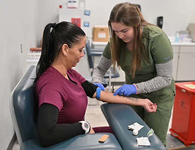 Medical Assisting student taking blood