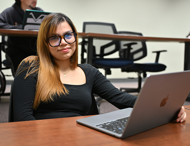 student in classroom with computer