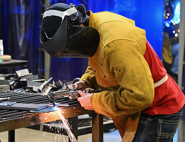 student working on welding project