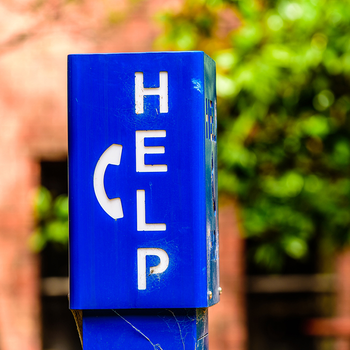 Help and phone on a blue pole