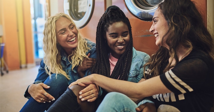 three-female-students-sitting-on-floor