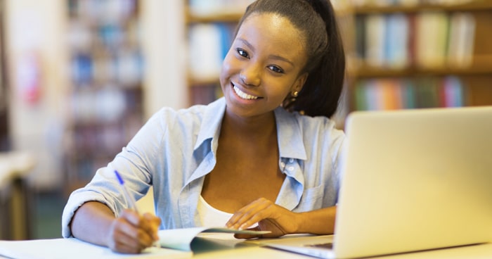 african-american-college-student-in-library-on-laptop