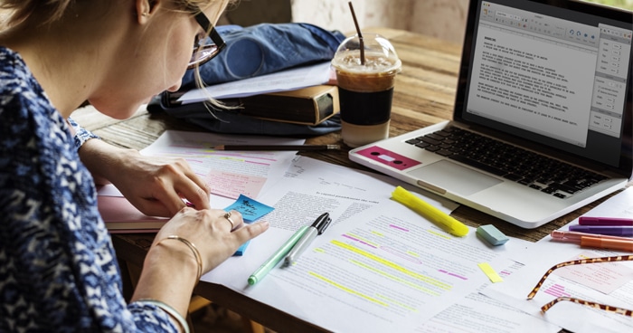 female-studying-with-notes-laptop