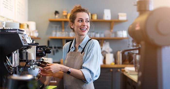 woman-making-cofee-at-machine