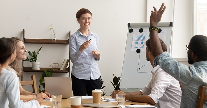 woman-leading-meeting-person-raising-hand