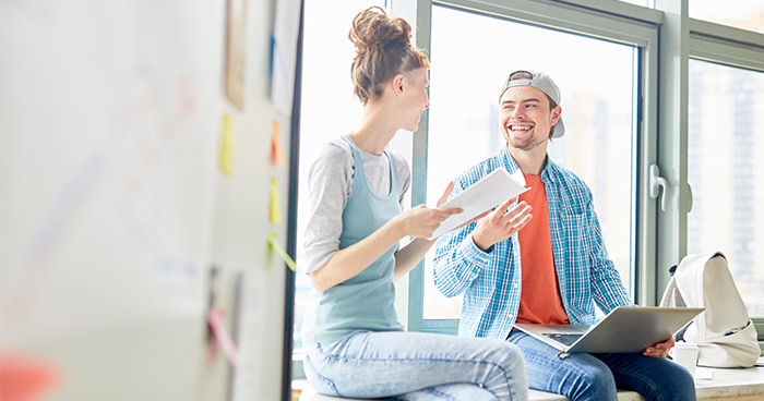 two-people-sitting-by-window-talking