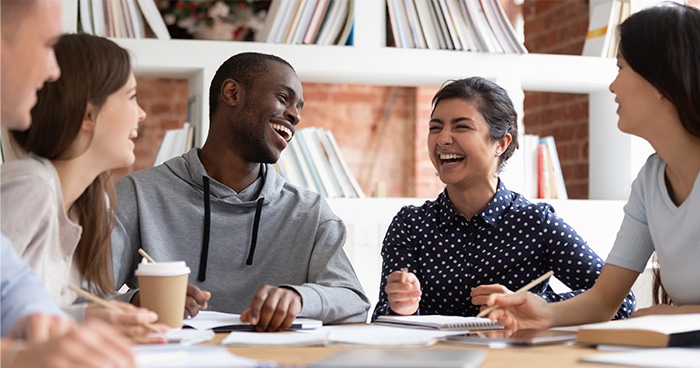 workers-sitting-at-table-laughing