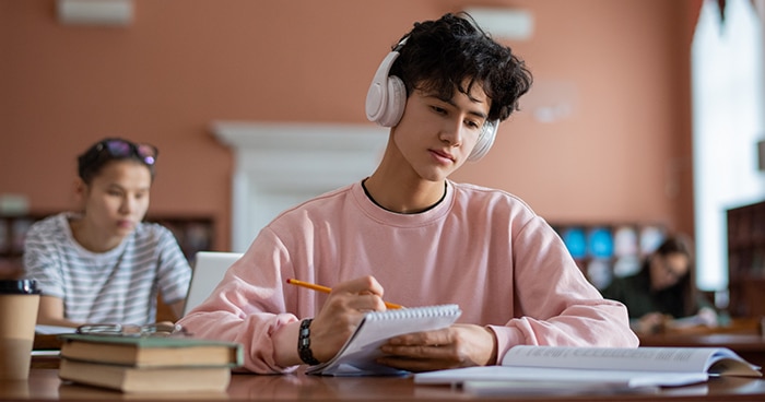 male-student-studying-with-ear-phones