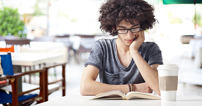 student-reading-a-book-with-coffee-cup