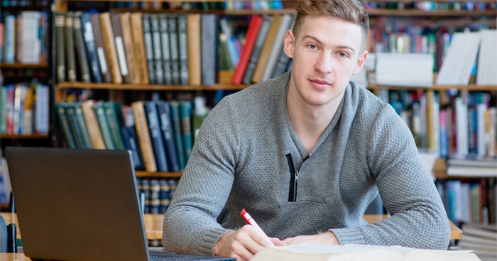 male-student-studying-at-library