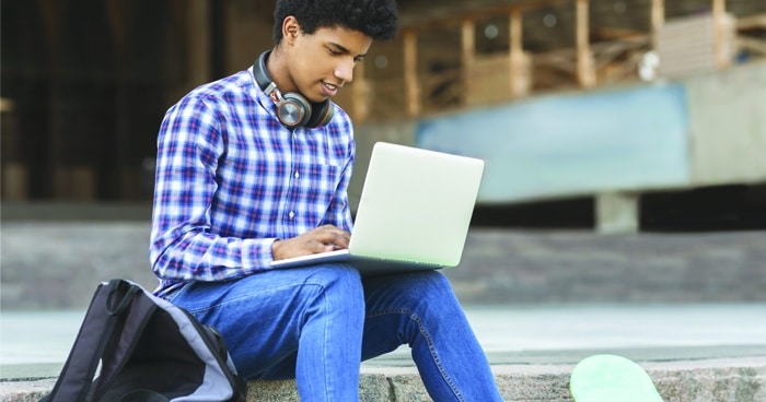 student-sitting-on-steps-with-laptop