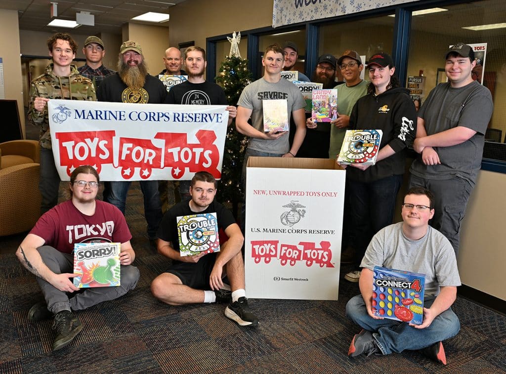 iowa-valley-grinnell-students-faculty-in-front-of-the-toys-for-tots-drop-off-box