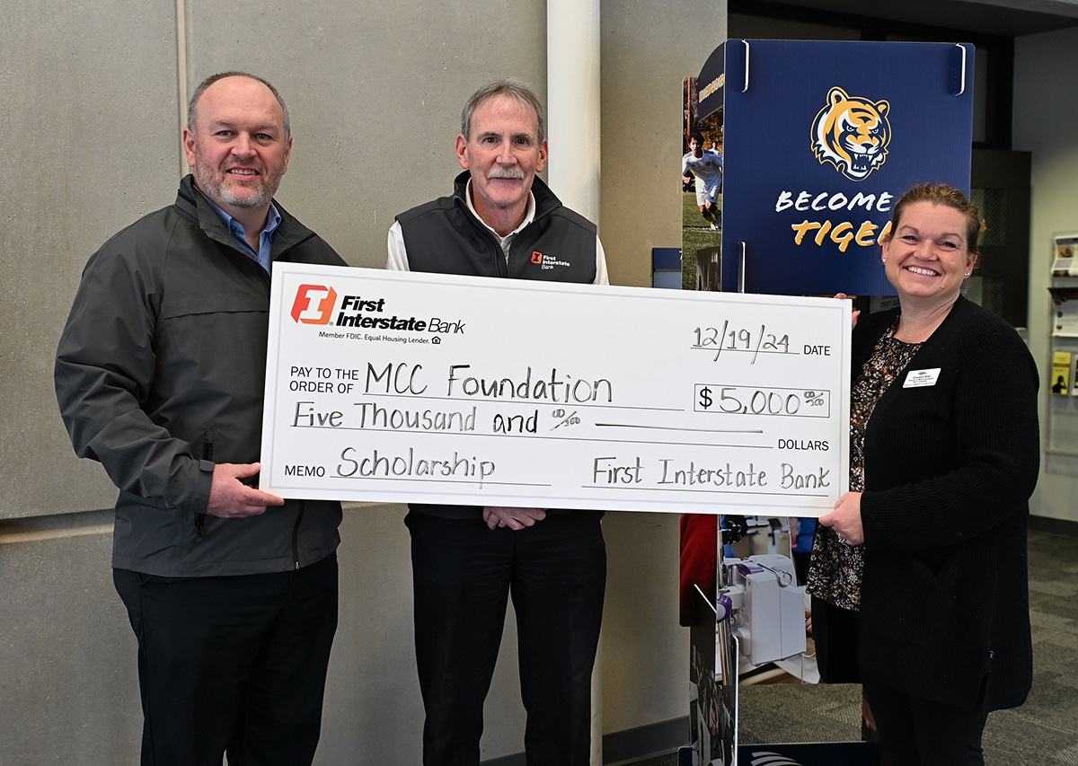 two-male-bank-employees-presenting-check-to-mcc-foundation