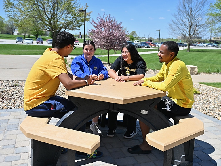 four-students-at-picnic-table